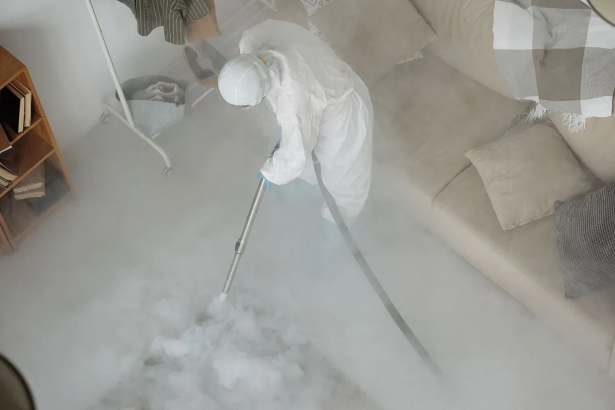 Biohazard cleanup technician in protective equipment, St. Michael, MN